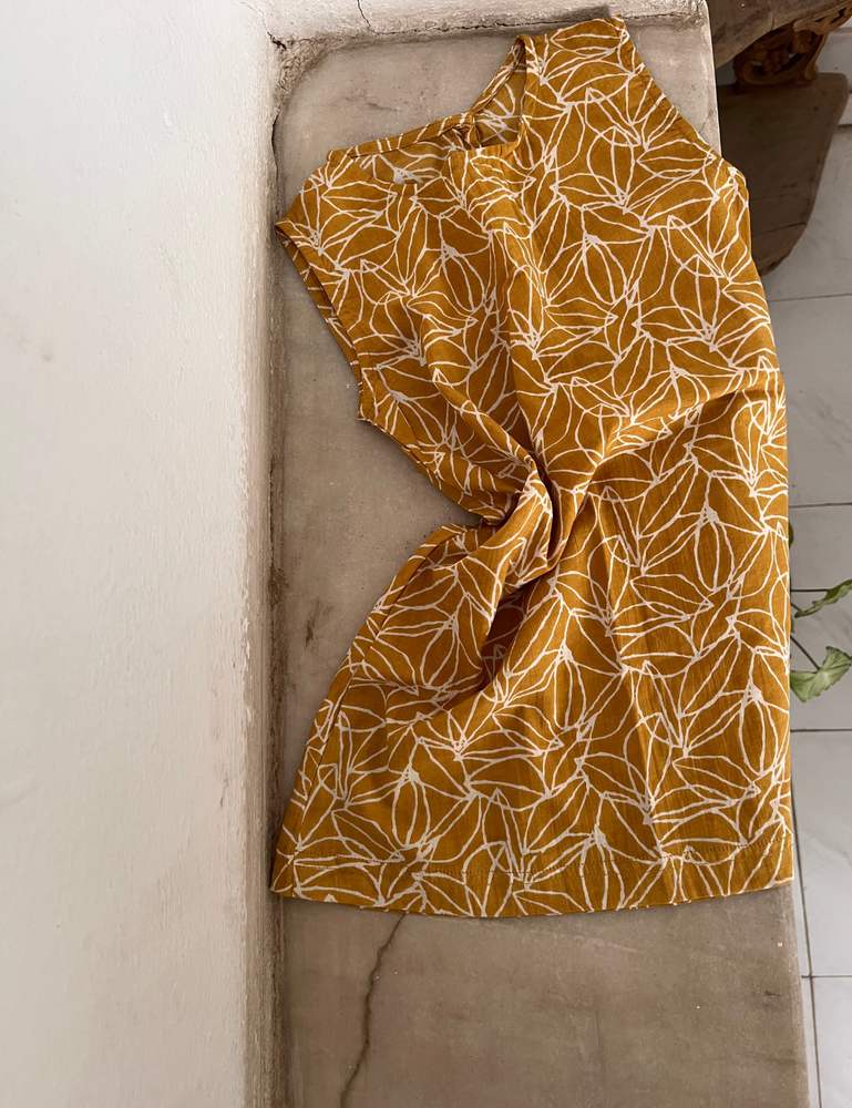 
                  
                    flatlay of kids fogo straight dress in mustard seed print on windowsill
                  
                