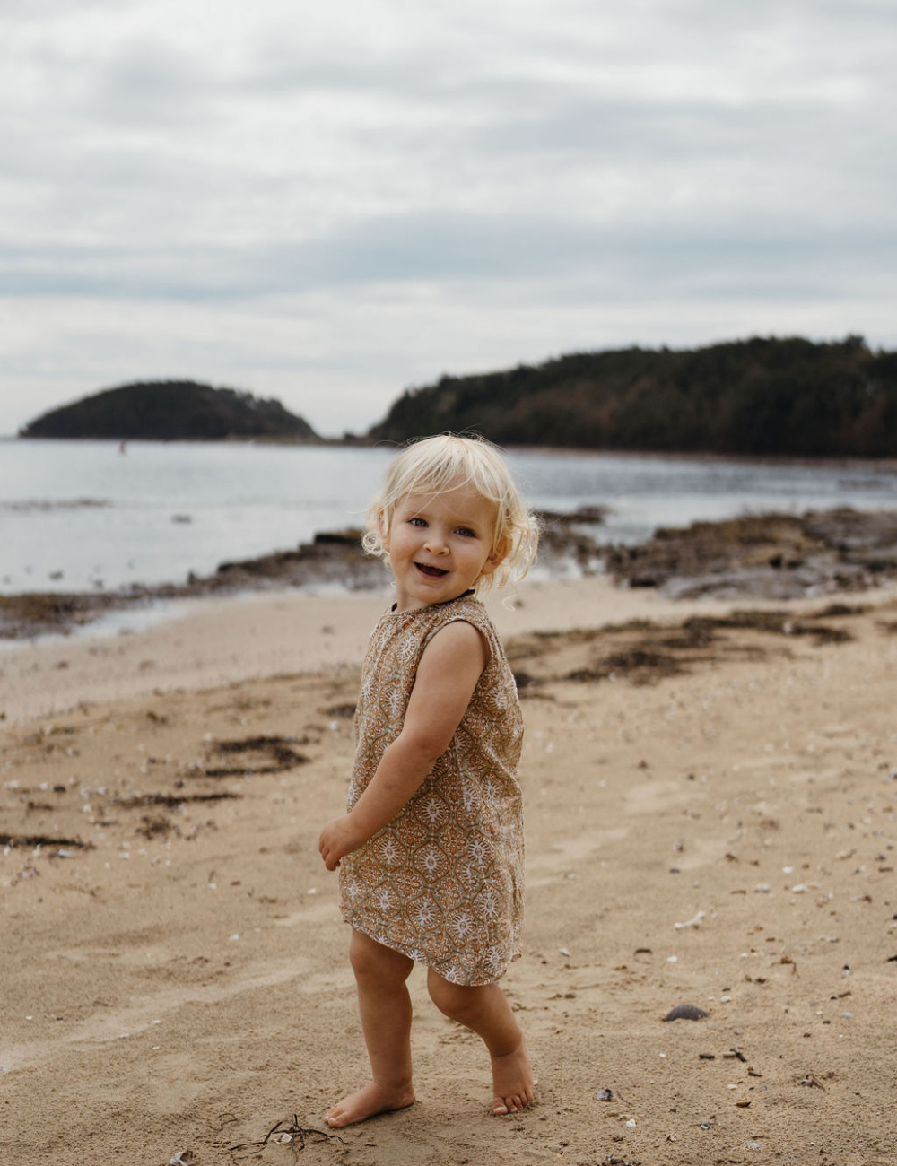 girl dancing on beach in fogo straight dress in retro funk print