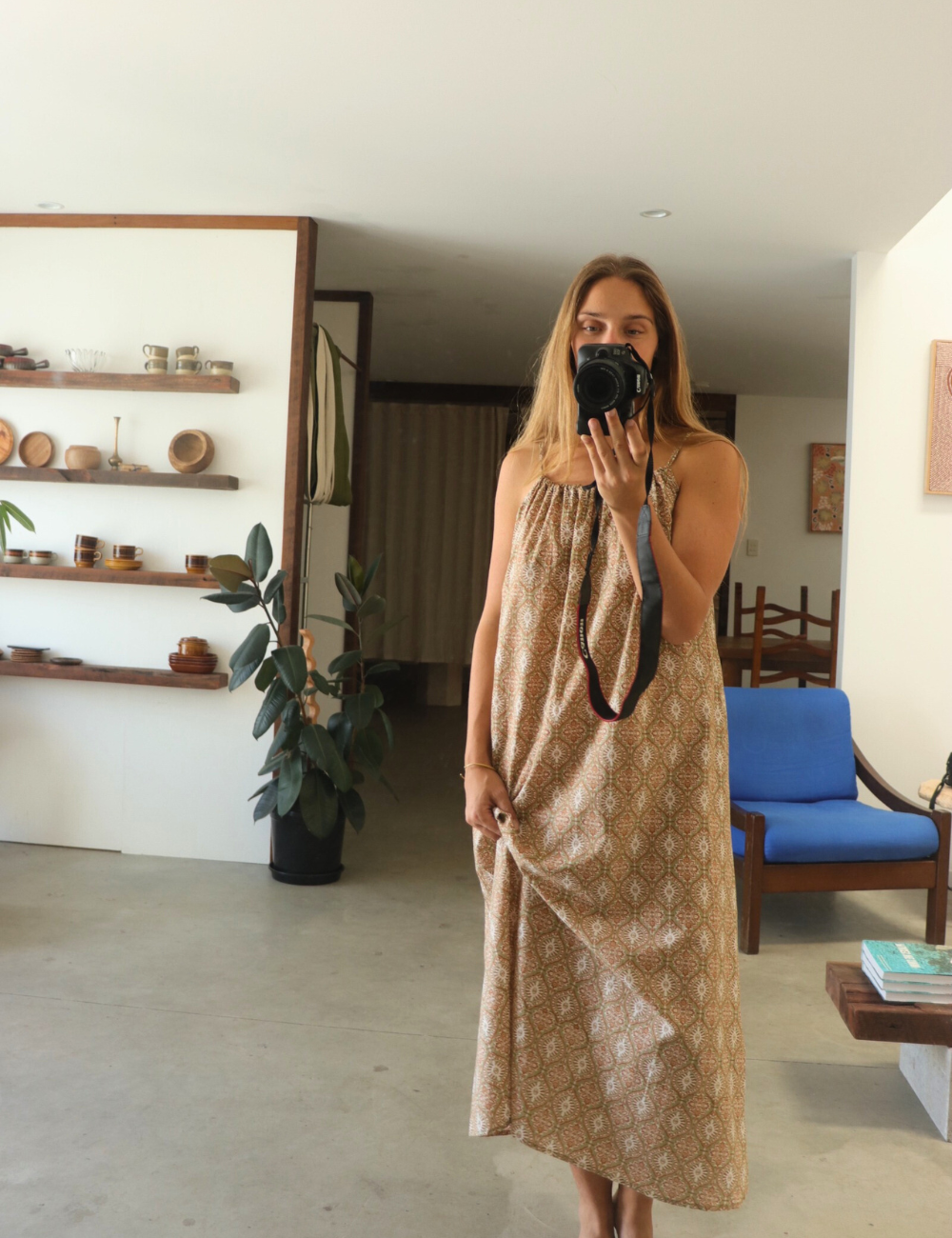 
                  
                    woman dressed in light patterned maxi dress in retro funk print in front of mirror in Byron Bay
                  
                