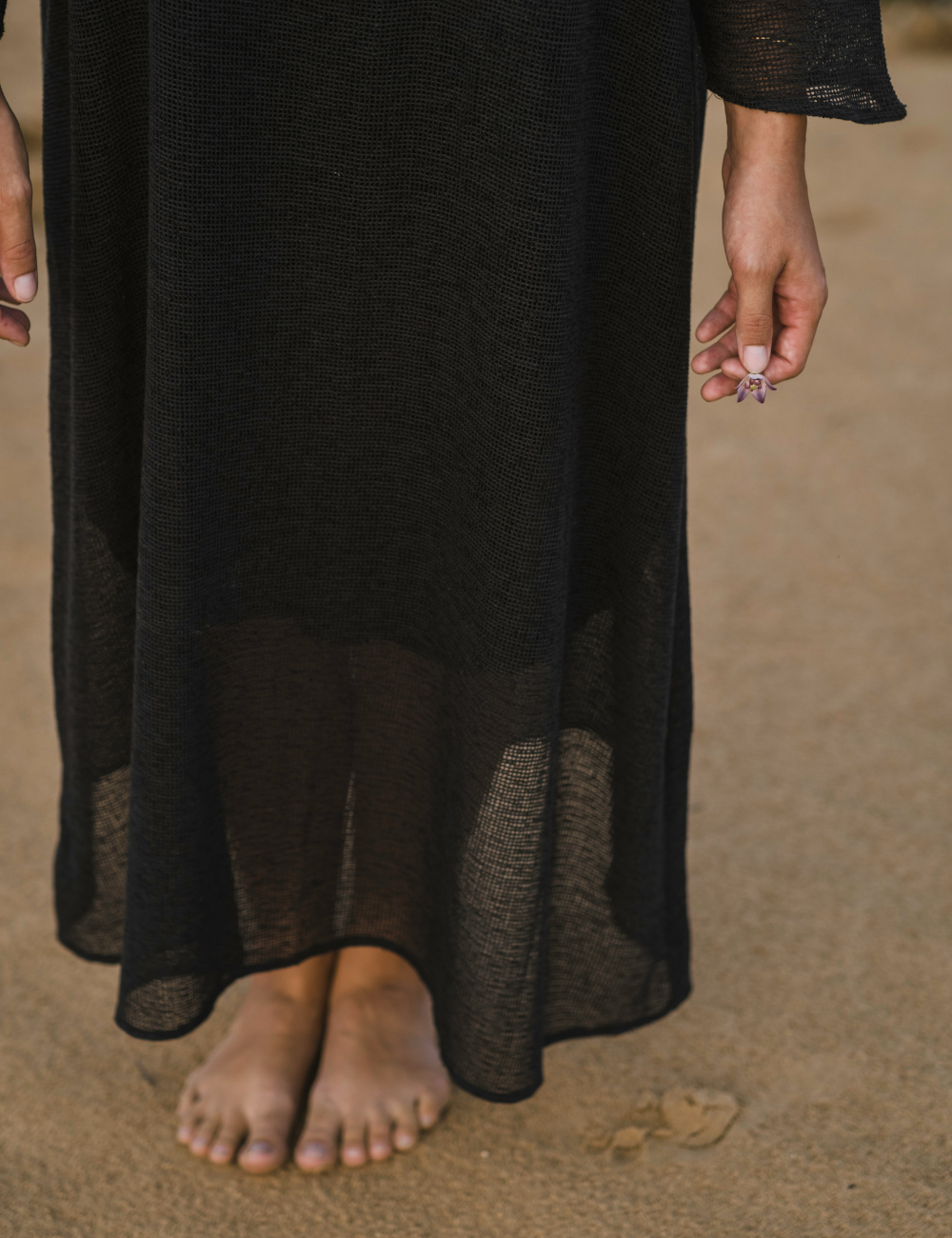 
                  
                    woman dressed in oversized maxi dress in net charcoal in Indian desert
                  
                