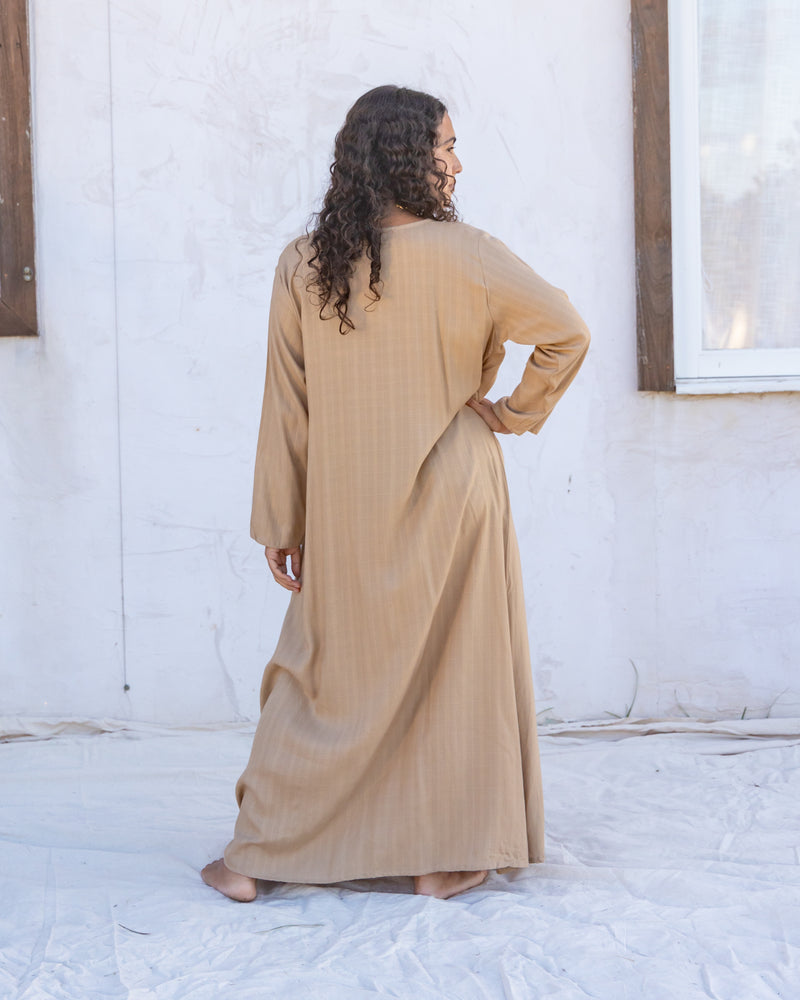 
                  
                    woman dressed in santo organic sugarcane wrap dress standing in front of a white wall
                  
                