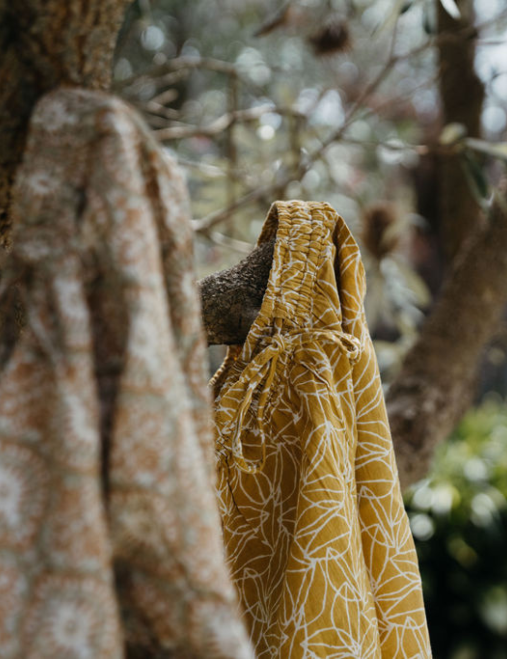 
                  
                    Indian retro block printed pants in retro funk and mustard seed print hanging on tree branch
                  
                