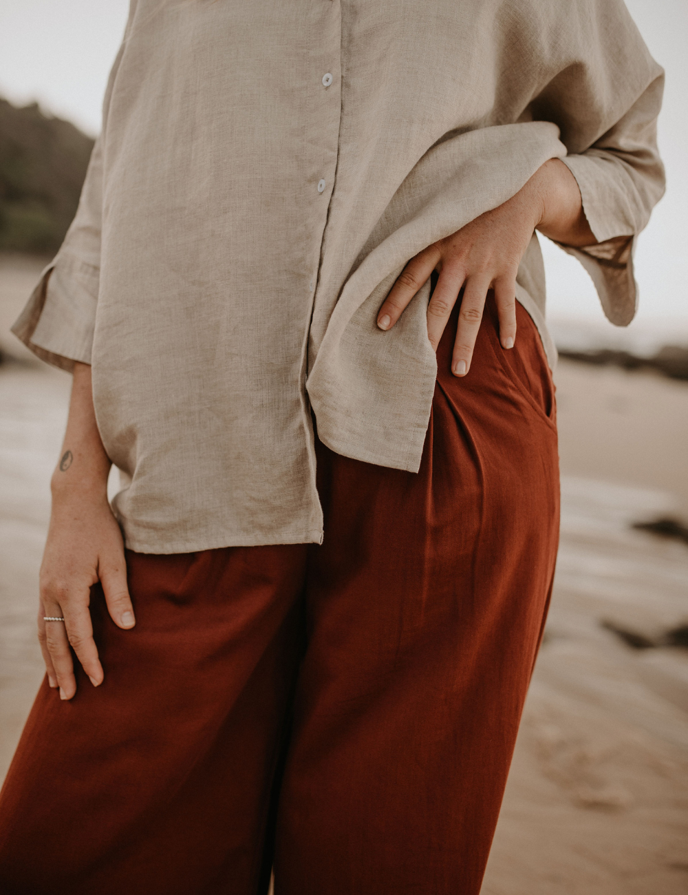 
                  
                    organic cotton pleated pants relaxed linen shirt sand natural woman sustainable clothing byron bay brand Zaya and Kai
                  
                